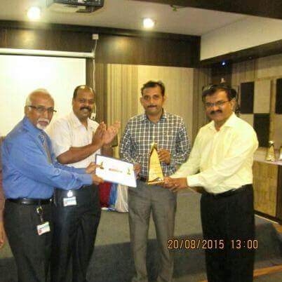 I am receiving the Branch Topper Trophy from the hands of Dynamic Speaker Murthy Sir